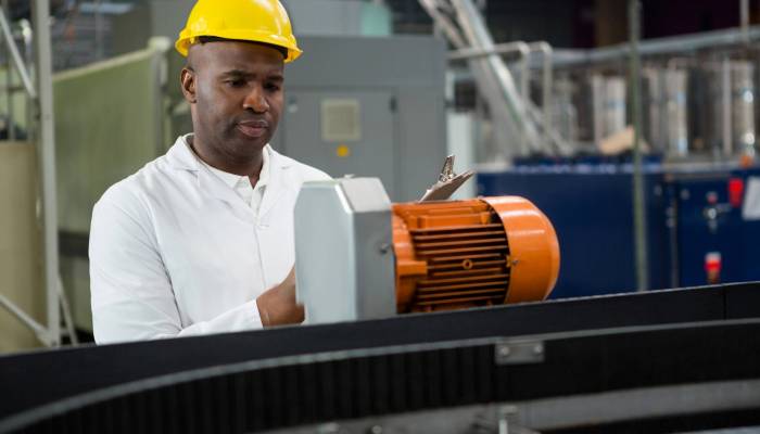 Engineer inspecting machines at juice factory